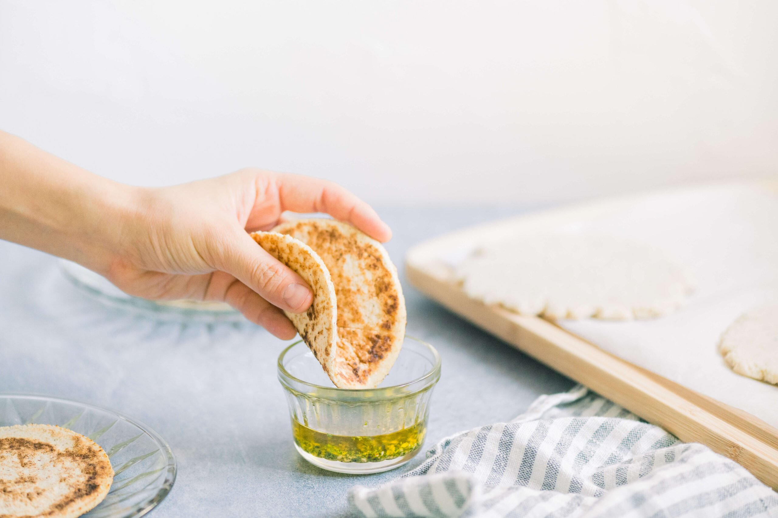 flatbread being dipped into seasoned oil